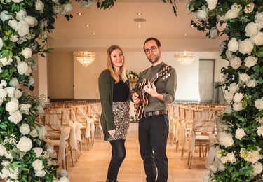 Music duo in wedding ceremony room with guitar