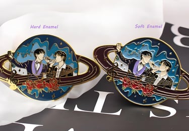 Comparison of hard enamel pins and soft enamel pins showing differences in texture, color depth, metal lines