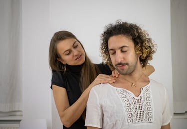 a woman massaging mans shoulders