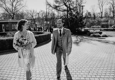 Bride and groom walking towards civil registry building.