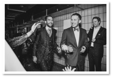 Two grooms during a send off in a club.