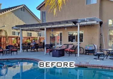 Two story home with old white lattice structure next to pool,