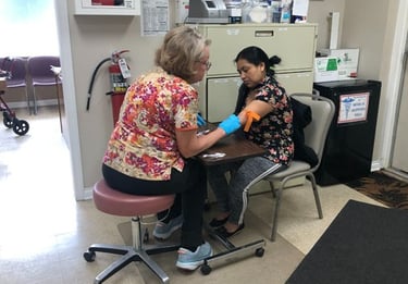 A patient having blood work done at the Center for Hope and Healing medical clinic