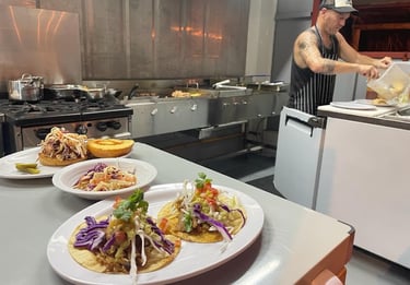 Fresh tacos, pulled pork sandwich and cole slaw. Barrel Bar & Grill restaurant kitchen.