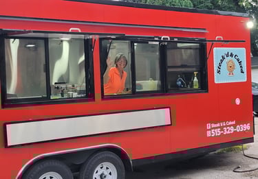 Cindy Niemier at serving window inside food trailer