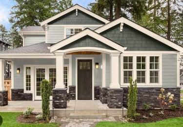 Exterior of a residential home with a front porch and gabled roof.