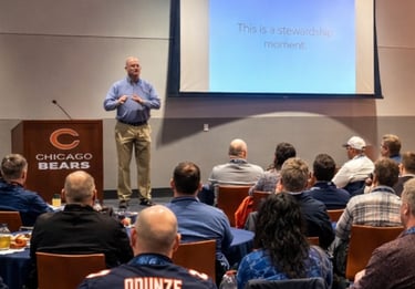 Mason Duchatschek speaking at a corporate retreat at the Chicago Bears Training Facility  