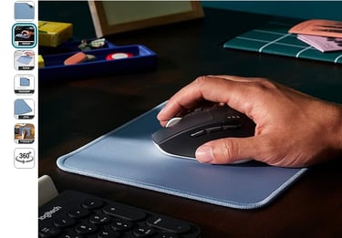 a person's hand holding a mouse pad