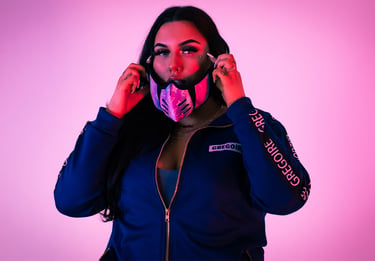 a woman in a blue jacket and a pink mask