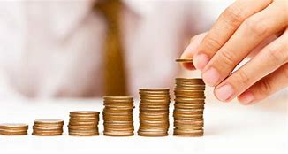 a man is putting coins into a stack of coins