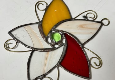 Stained glass star with amber, cream, and red glass