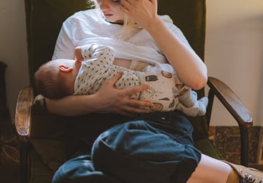 Mother breastfeeding baby highlighting benefits of breast milk in Niagara