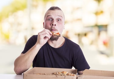 a man eating pizza