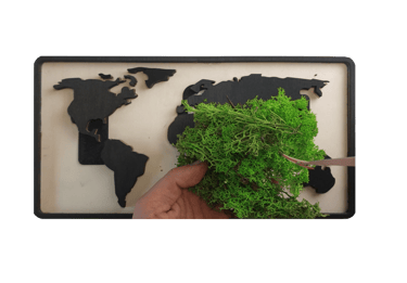 a person cutting a piece of wood with a map of the world