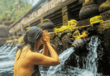 a woman in a bikini top standing in a river