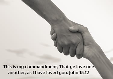 black and white photo of two hands hands together, featuring the verse John 15:12.
