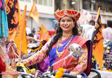 woman in maharastrian traditional outfit riding a motorbike in girgaon gudipadwa shobhayatra 2025