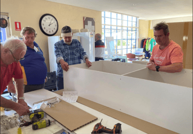 President Keith, Graham, Secretary Andrew, and Dave make sure the measurements are right.