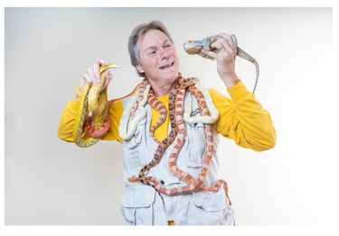 Rick Teepen holding snakes and a bearded dragon
