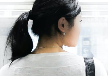 An Asian woman looks over her shoulder