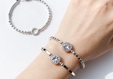 A collection of colorful imitation gemstone rings arranged on a wooden tray