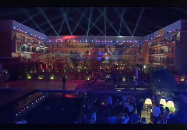 a man standing in front of a pool with a crowd of people