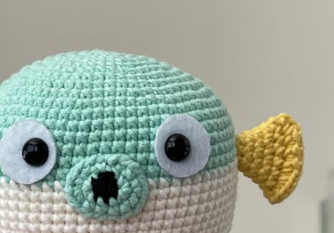 a handmade crochet fish toy with big eyes