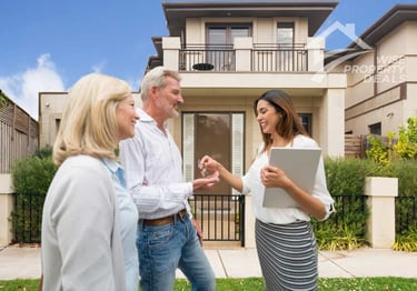 a couple and their family standing in front of a house