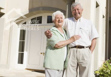 a man and woman standing in front of a house