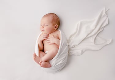 a baby is sleeping in a blanket wrapped in a blanket