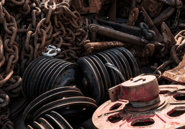 a pile of old rusty metal and chains