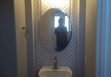 a person taking a selfie in a mirror in a bathroom