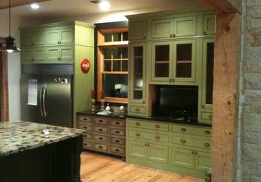 a kitchen with green farmhouse cabinets