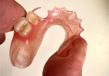 a person holding a toothbrush and a toothbrush