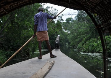 Man punting a boat in boat in Kochi, Kerala, India