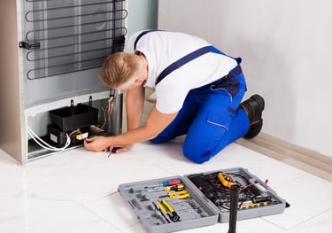 a technician repairing a compressor of a refrigerator