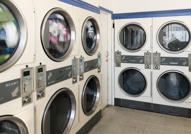 commercial laundry room with coin operated washers and dryers