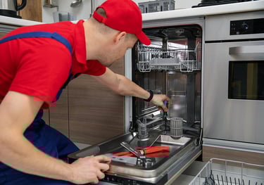 a person red hat repairing a dishwasher 
