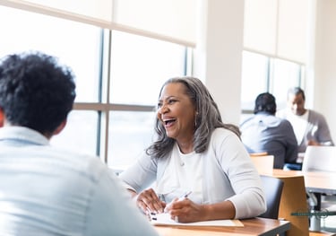 admission counselor laughing and meeting with a potential student