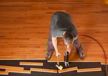 Handyman working on hardwood installation
