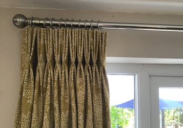 Curtains with stitched triple pleats in a yellow fabric chosen from one of my sample books.