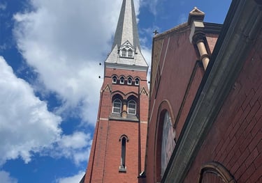 a church with a steeple tower in the background