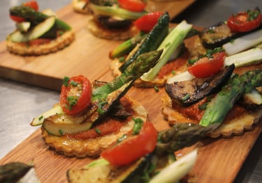 a wooden board with a variety of vegetables tart