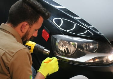 a man in a yellow glove is using a drillet to wrap car
