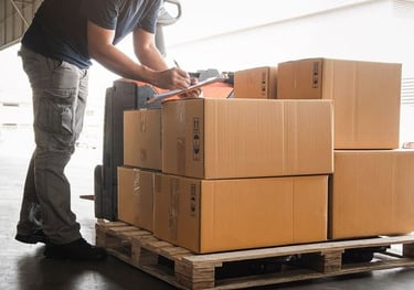 a man is standing in front of a stack of boxes