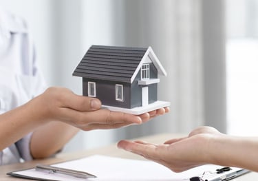 a woman holding a small house model FOR HOME LOANS PROMOTION
