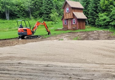 excavator and house on cleared land