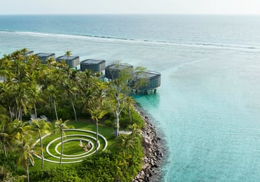 a circular shaped object in the middle of a body of water, The Ritz Carlton Maldives
