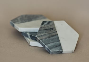 a pair of marbled coasters with a marbled surface