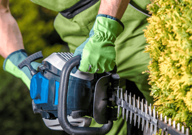 a man in a green shirt is holding a chainsawl